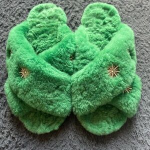 Green sheepskin slippers with starburst rhinestones and rubber bottoms, size 8